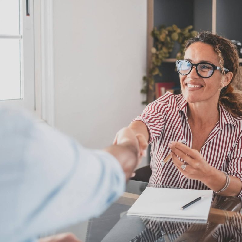 smiling-caucasian-female-hr-manager-handshake-hire-male-candidate-at-job-interview.jpg